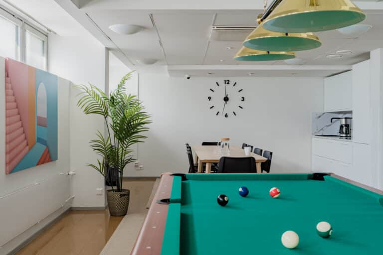 Club room with billiards table and modern kitchen facilities, providing international and local students with a welcoming accommodation environment